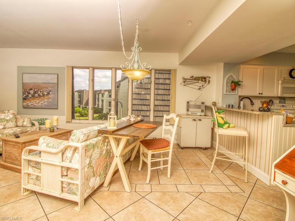 1633 Spoonbill Lane, Unit 1633C Naples, FL 34105 - Photo 12 of 35 a very nice looking dining room with a table and chairs