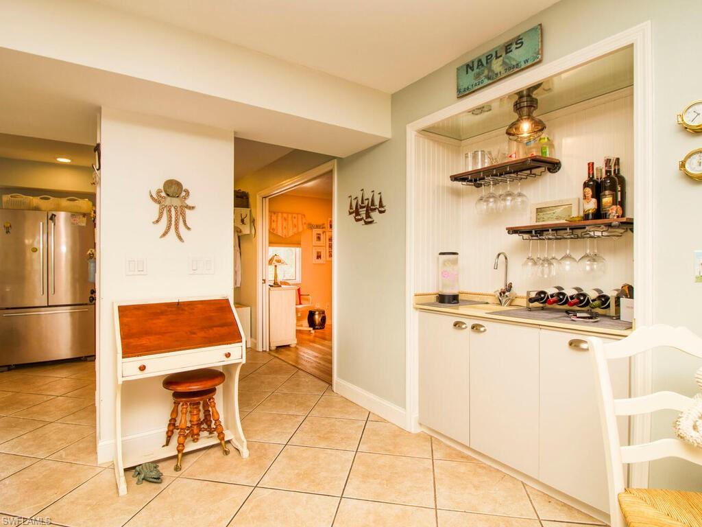 1633 Spoonbill Lane, Unit 1633C Naples, FL 34105 - Photo 15 of 35 a room with furniture and a window