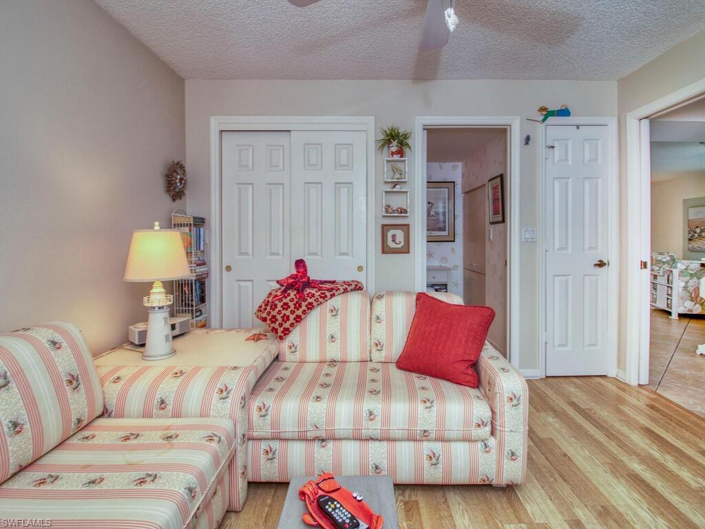 1633 Spoonbill Lane, Unit 1633C Naples, FL 34105 - Photo 18 of 35 a bedroom with a bed and a couch