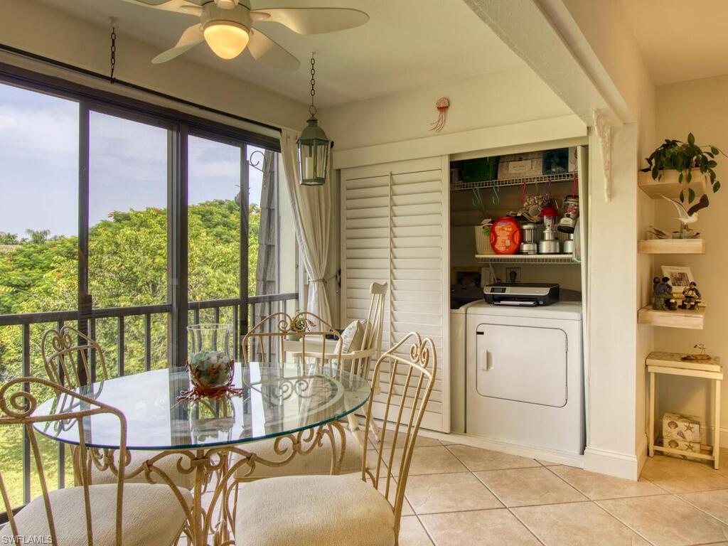 1633 Spoonbill Lane, Unit 1633C Naples, FL 34105 - Photo 20 of 35 a dining room with furniture and a floor to ceiling window