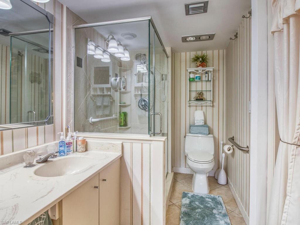 1633 Spoonbill Lane, Unit 1633C Naples, FL 34105 - Photo 24 of 35 a bathroom with a sink toilet and shower
