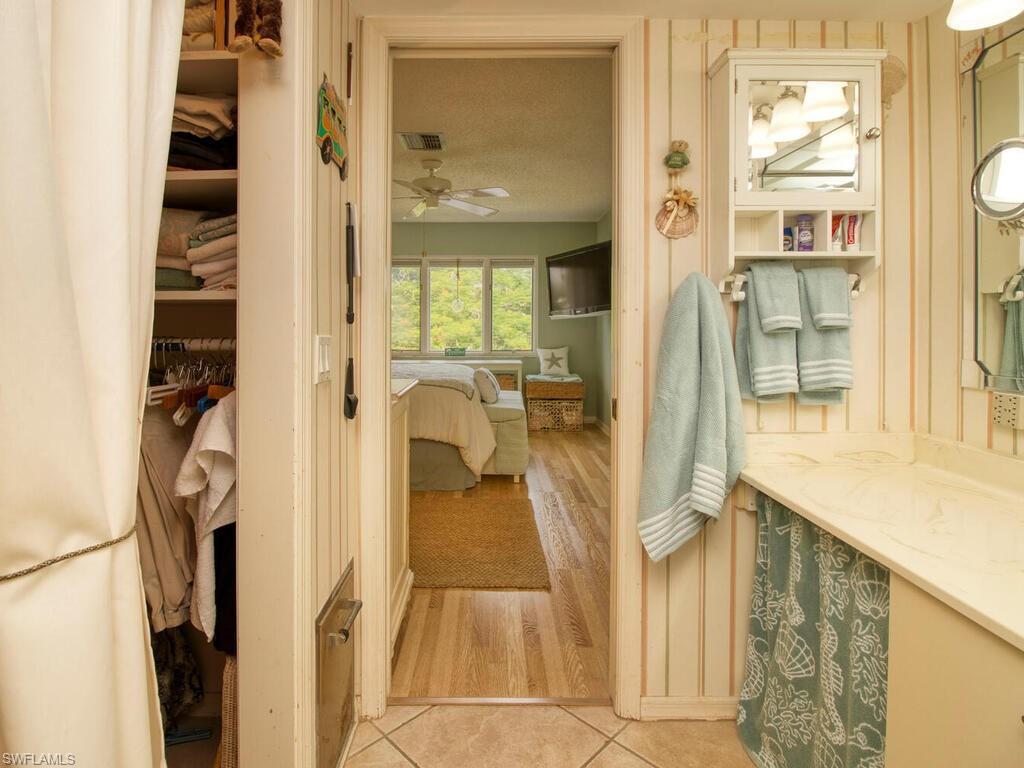 1633 Spoonbill Lane, Unit 1633C Naples, FL 34105 - Photo 25 of 35 view of living room with furniture and wooden floor