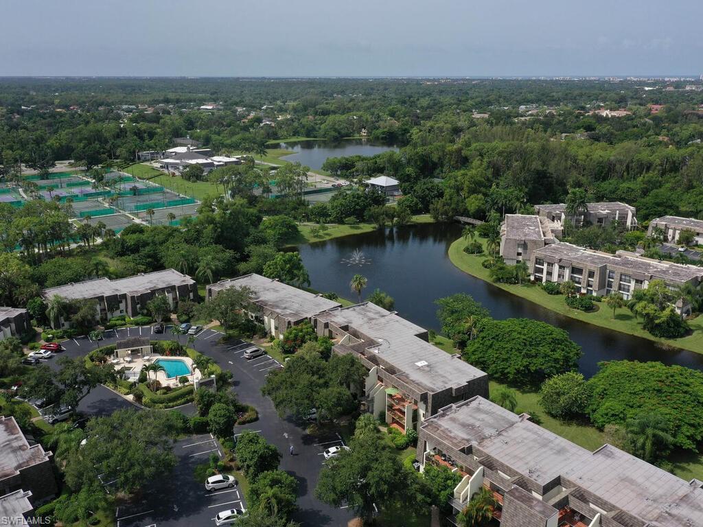 1633 Spoonbill Lane, Unit 1633C Naples, FL 34105 - Photo 30 of 35 an aerial view of a house with a lake view