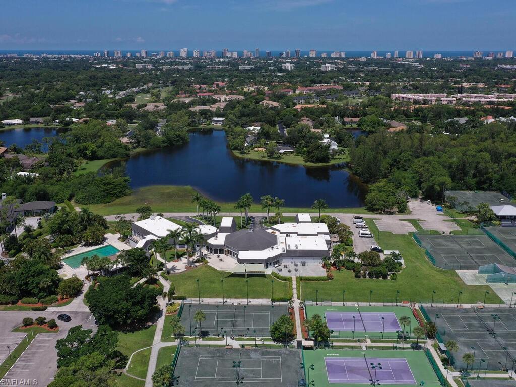 1633 Spoonbill Lane, Unit 1633C Naples, FL 34105 - Photo 35 of 35 an aerial view of residential houses with outdoor space and trees