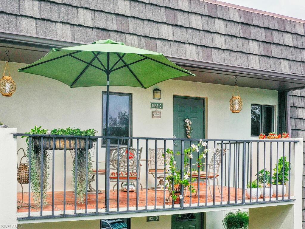 1633 Spoonbill Lane, Unit 1633C Naples, FL 34105 - Photo 4 of 35 a view of a house with a small yard and deck