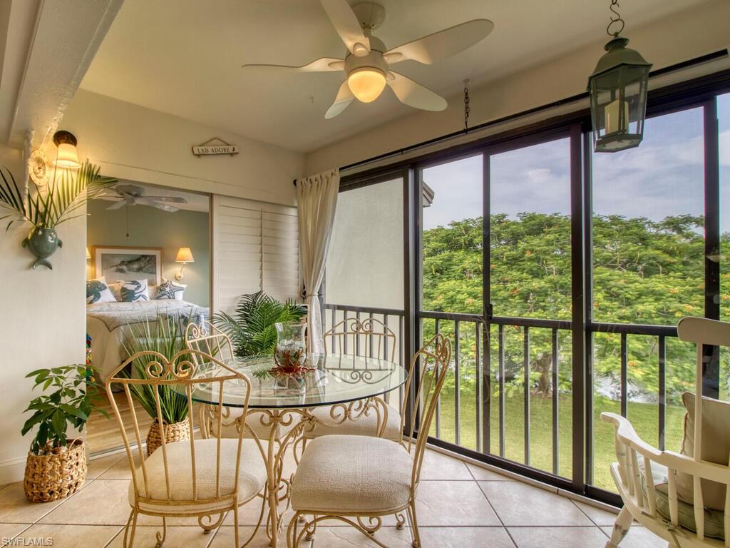 1633 Spoonbill Lane, Unit 1633C Naples, FL 34105 - Photo 9 of 35 a view of a dining room with furniture window and outside view