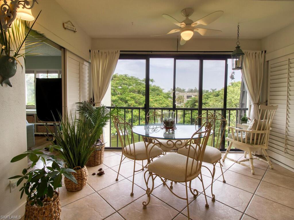 1633 Spoonbill Lane, Unit 1633C Naples, FL 34105 - Photo 10 of 35 a living room with furniture and a large window