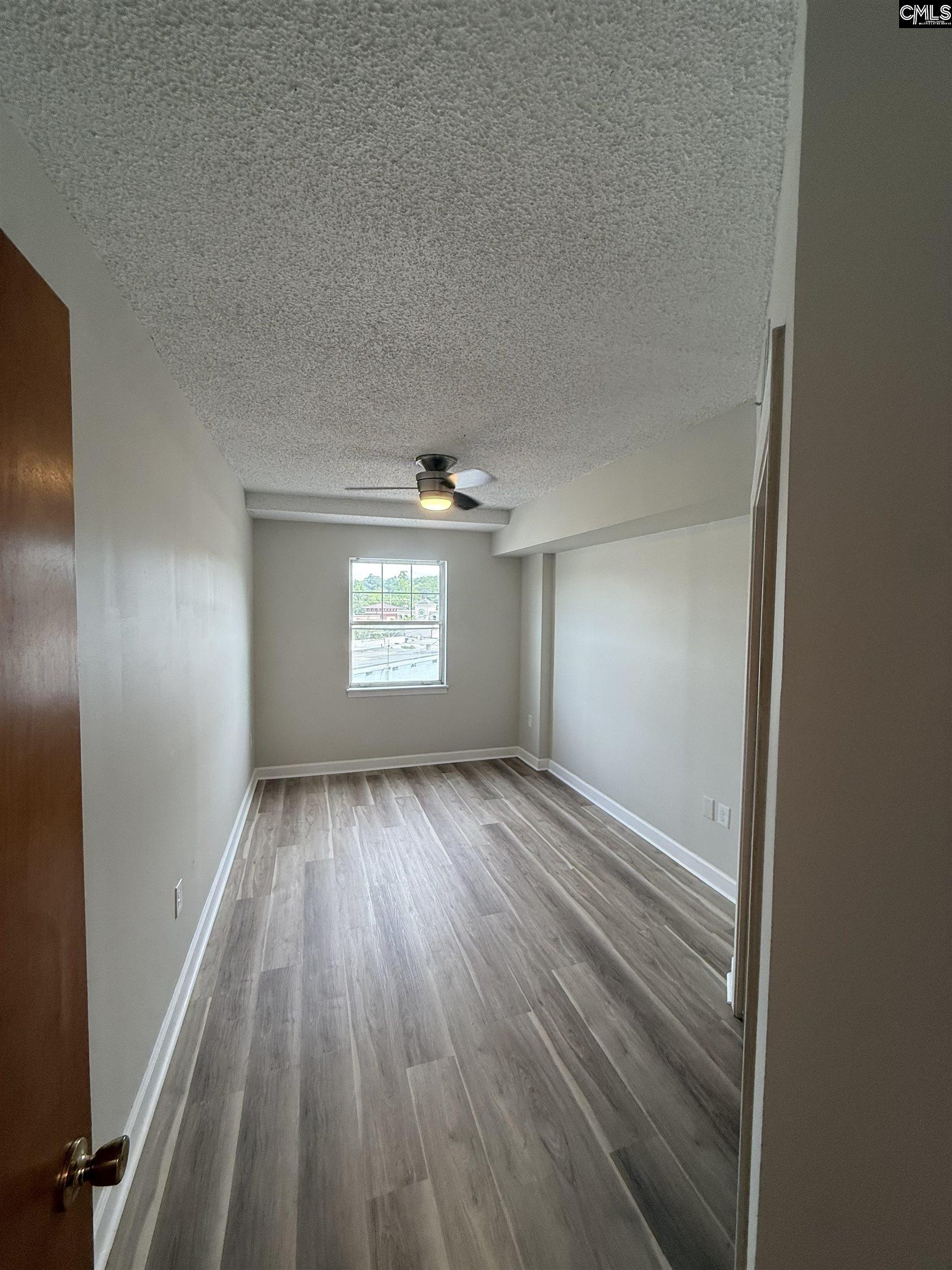 2002 Greene Street, Unit 209 Columbia, SC 29205 - Photo 9 of 22 wooden floor in an empty room with a window