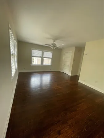 a view of a room with wooden floor and windows