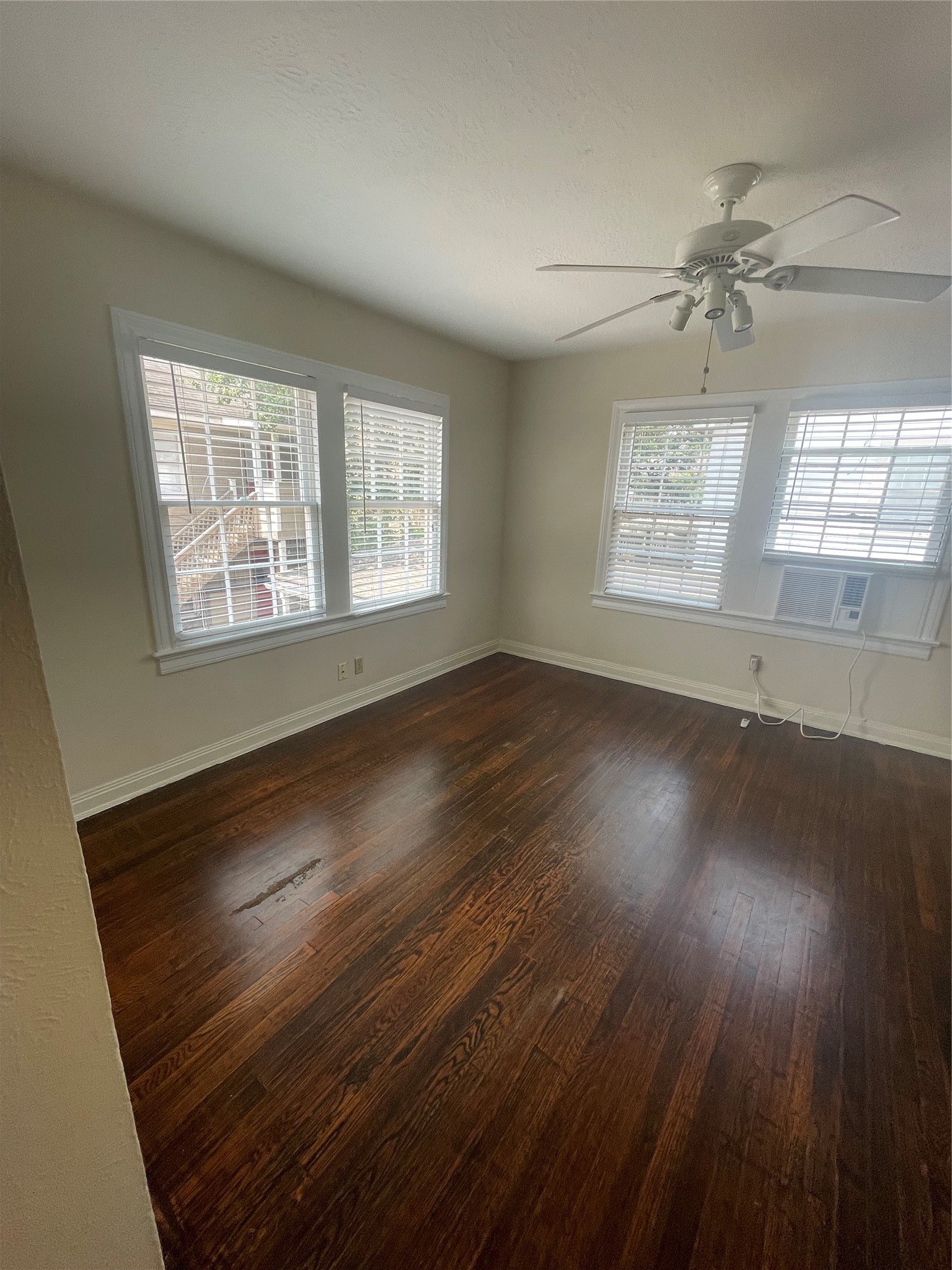 2030 Bissonnet Street Houston, TX 77005 - Photo 22 of 25 an empty room with wooden floor chandelier and windows
