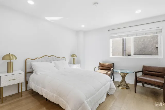 a bedroom with bed and chair