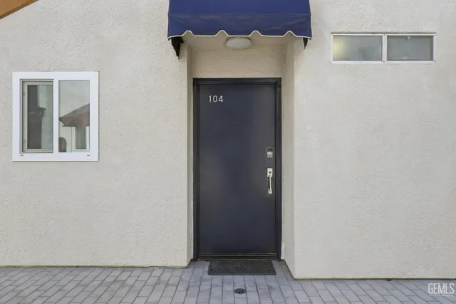 a view of a hallway with wooden floor and a cabinet