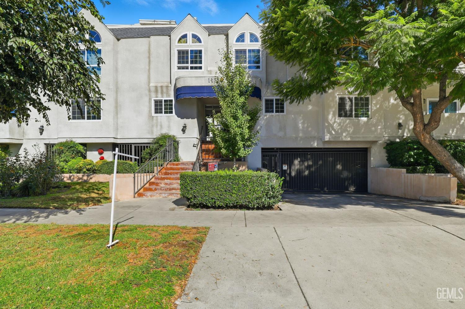 Undisclosed Address North Hollywood, CA 91602 - Photo 22 of 30 a front view of a house with a yard and garage