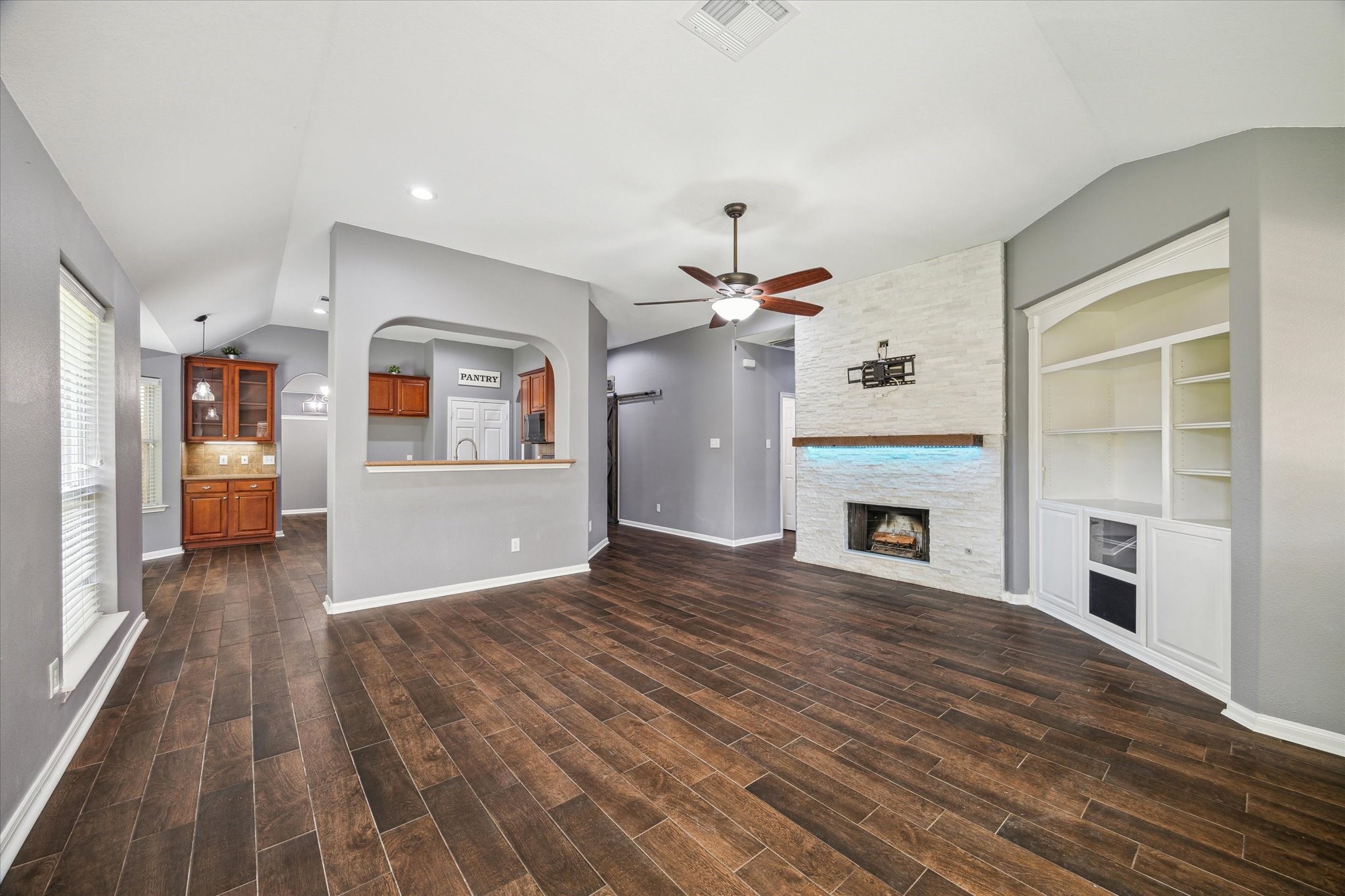 20910 Sandy Briar Court Spring, TX 77379 - Photo 12 of 28 a view of a livingroom with wooden floor and a kitchen