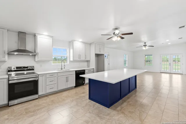 a kitchen with stainless steel appliances granite countertop a stove oven and a refrigerator