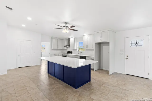 a kitchen with stainless steel appliances cabinets a sink and a refrigerator