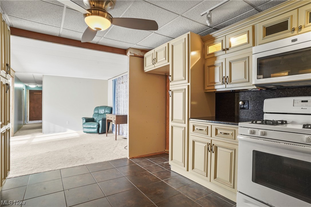 418 East Caston Road, Unit C1 Akron, OH 44319 - Photo 6 of 20 Kitchen featuring white appliances, cream cabinets, ceiling fan, and dark tile floors