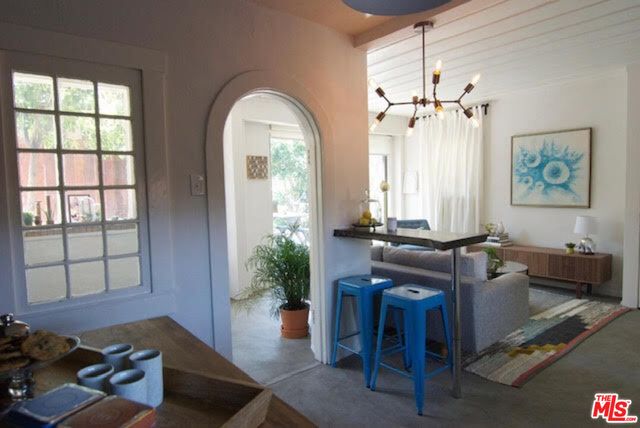 a view of a livingroom with furniture and a window