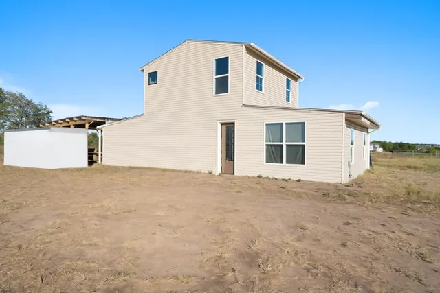 a view of a house with a yard and garage
