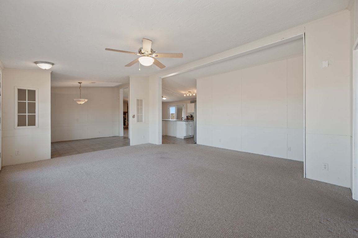 1600 County Road 465 Elgin, TX 78621 - Photo 4 of 25 a view of a big room with chandelier fan and windows
