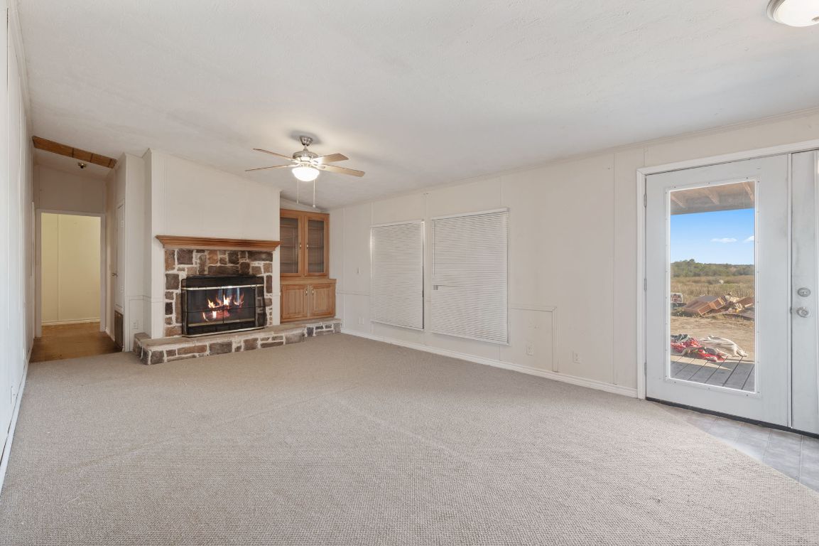 1600 County Road 465 Elgin, TX 78621 - Photo 7 of 25 a view of an empty room with a fireplace