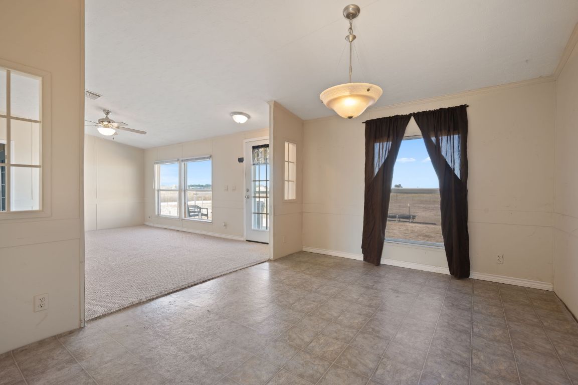 1600 County Road 465 Elgin, TX 78621 - Photo 8 of 25 a view of a room with large windows and ceiling fan