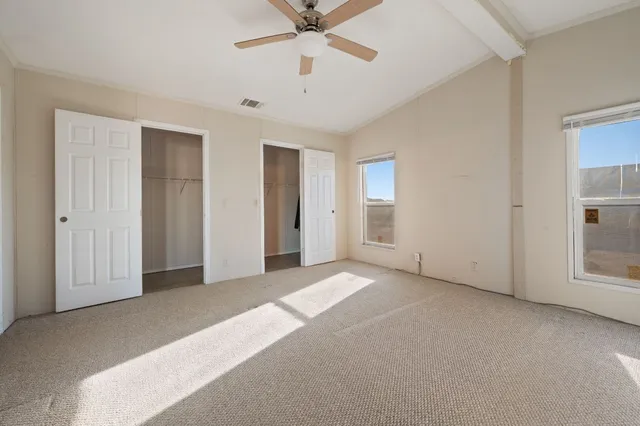 a view of a livingroom with a ceiling fan and window