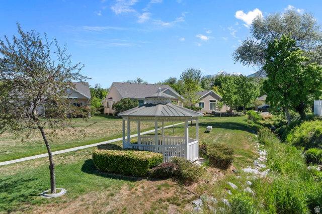 1417 Blacksmith Lane Draper, UT 84020 - Photo 48 of 57 White gazebo with a multi-tiered roof, surrounded by green lawns and mature trees