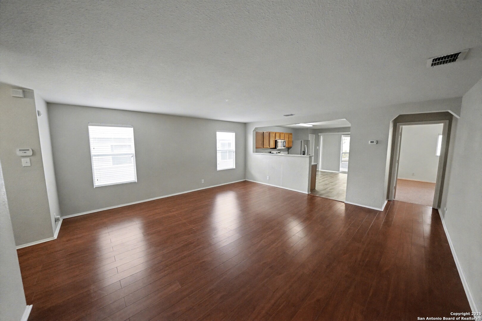 3615 Longhorn Creek San Antonio, TX 78261 - Photo 11 of 42 a view of an empty room with wooden floor and a window