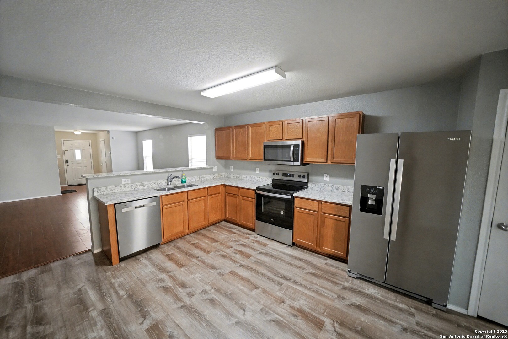 3615 Longhorn Creek San Antonio, TX 78261 - Photo 13 of 42 a large kitchen with a stove a sink dishwasher a refrigerator and a microwave oven