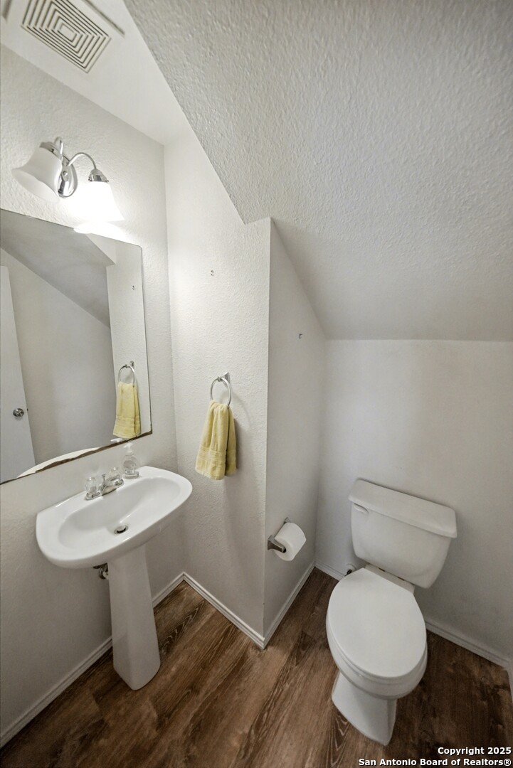 3615 Longhorn Creek San Antonio, TX 78261 - Photo 22 of 42 a bathroom with a toilet sink and mirror