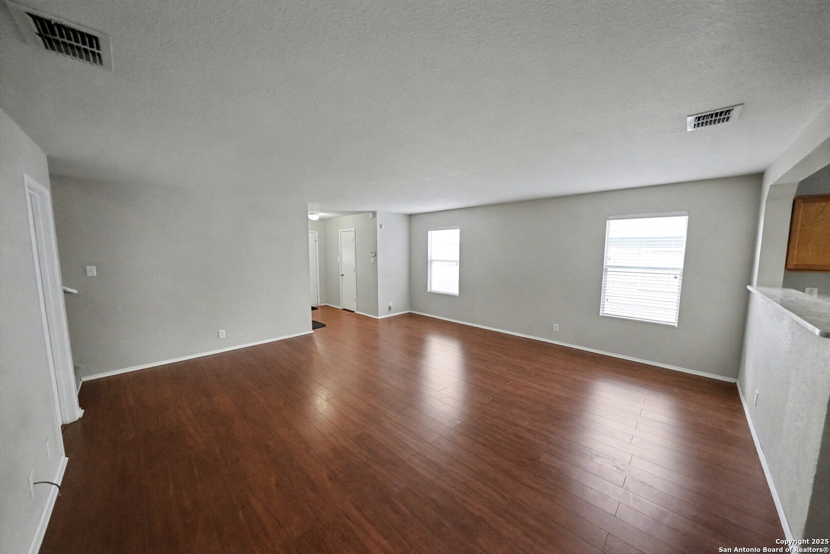 3615 Longhorn Creek San Antonio, TX 78261 - Photo 10 of 42 a view of an empty room with wooden floor and a window