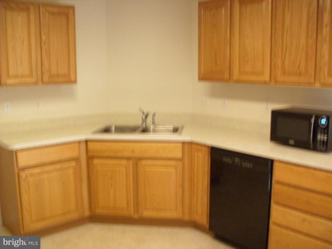 117 Hess Road Grasonville, MD 21638 - Photo 5 of 9 a kitchen with stainless steel appliances granite countertop white cabinets a sink and dishwasher