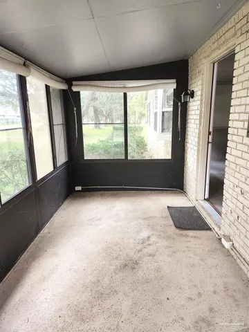 an empty room with large windows