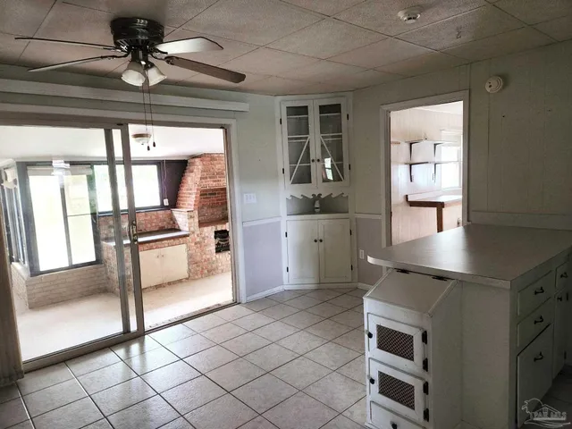a open kitchen with white cabinets and white appliances
