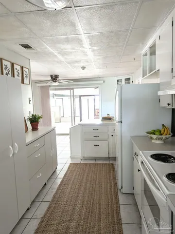 a kitchen with cabinets and wooden floor