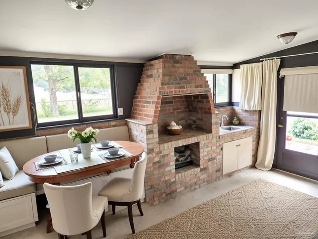 a dining room with a window a table and chairs