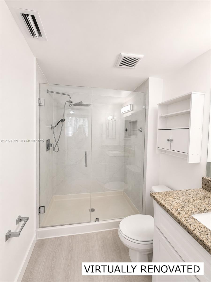 8761 Wiles Road, Unit 206 Coral Springs, FL 33067 - Photo 7 of 26 a bathroom with a shower a toilet and a glass door
