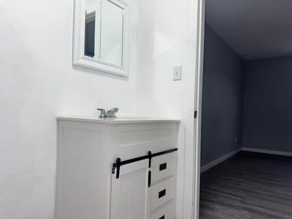 a view of a kitchen with wooden floor