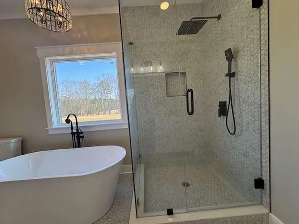 a bathroom with a bathtub and shower