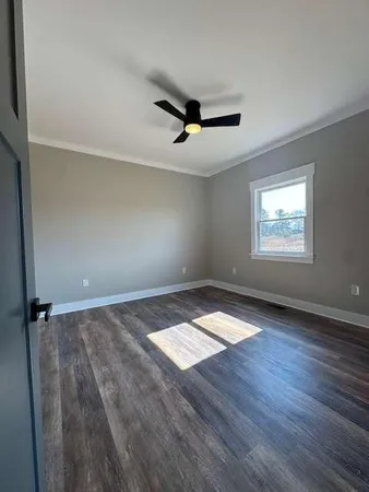 wooden floor in an empty room with a window