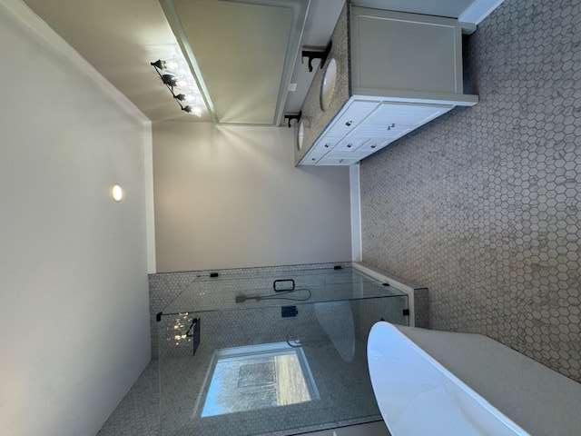 1825 County Road 40, AL 35960 - Photo 10 of 24 a spacious bathroom with a double vanity sink a mirror and a bathtub