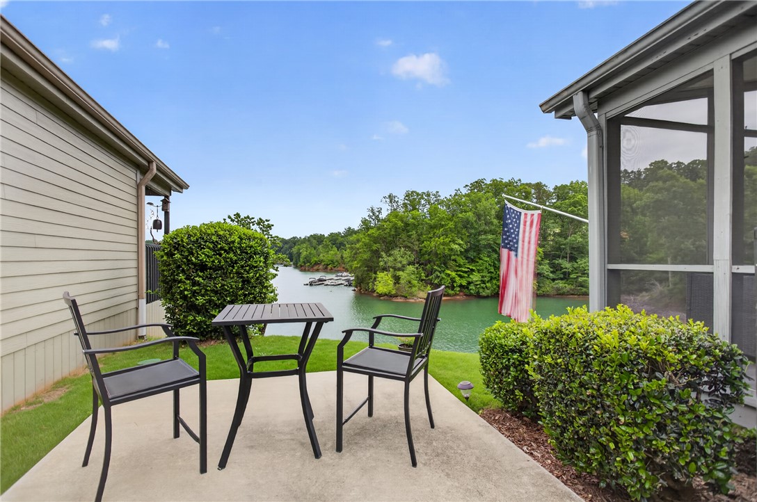1230 Melton Road, Unit 4 West Union, SC 29696 - Photo 16 of 48 Enjoy tranquil lake views from this well-appointed patio, perfect for unwinding.