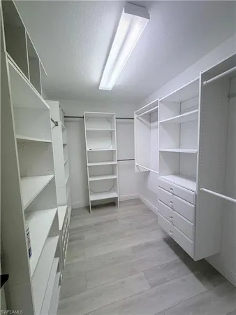 a view of a room with wooden floor and flat screen tv