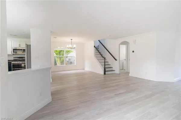 a kitchen with granite countertop white cabinets and stainless steel appliances