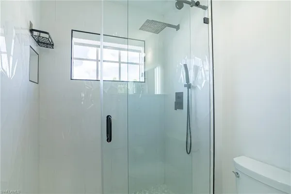 a kitchen with granite countertop white cabinets and stainless steel appliances