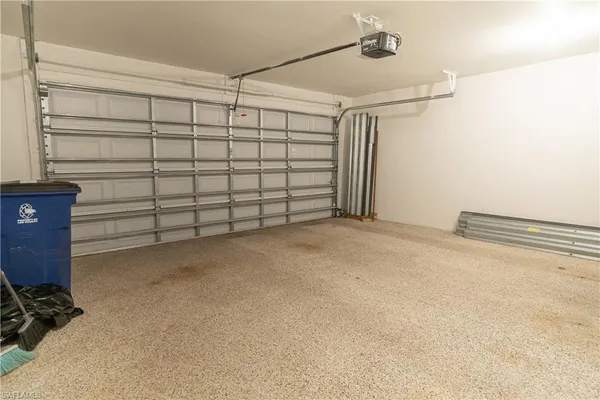 a white toilet sitting next to a white wall