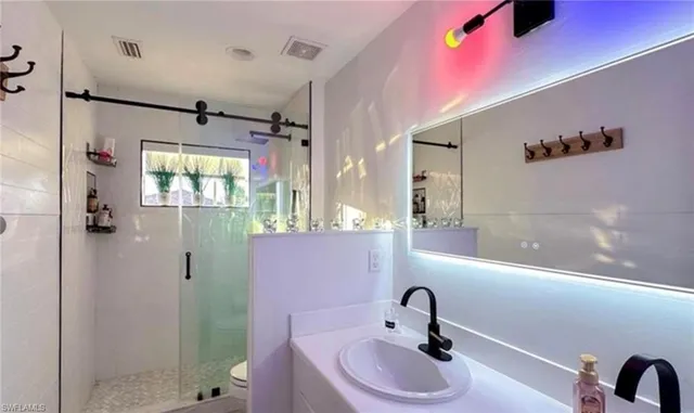 a bathroom with a sink and mirror