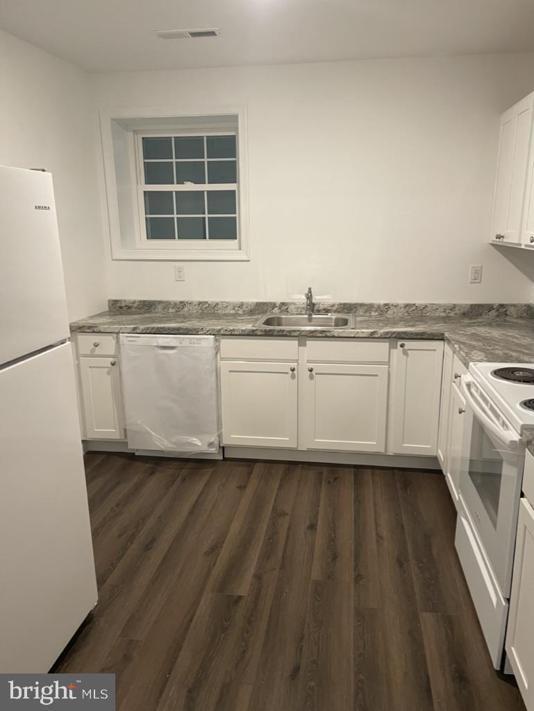 a view of a kitchen with granite countertop cabinets and a sink