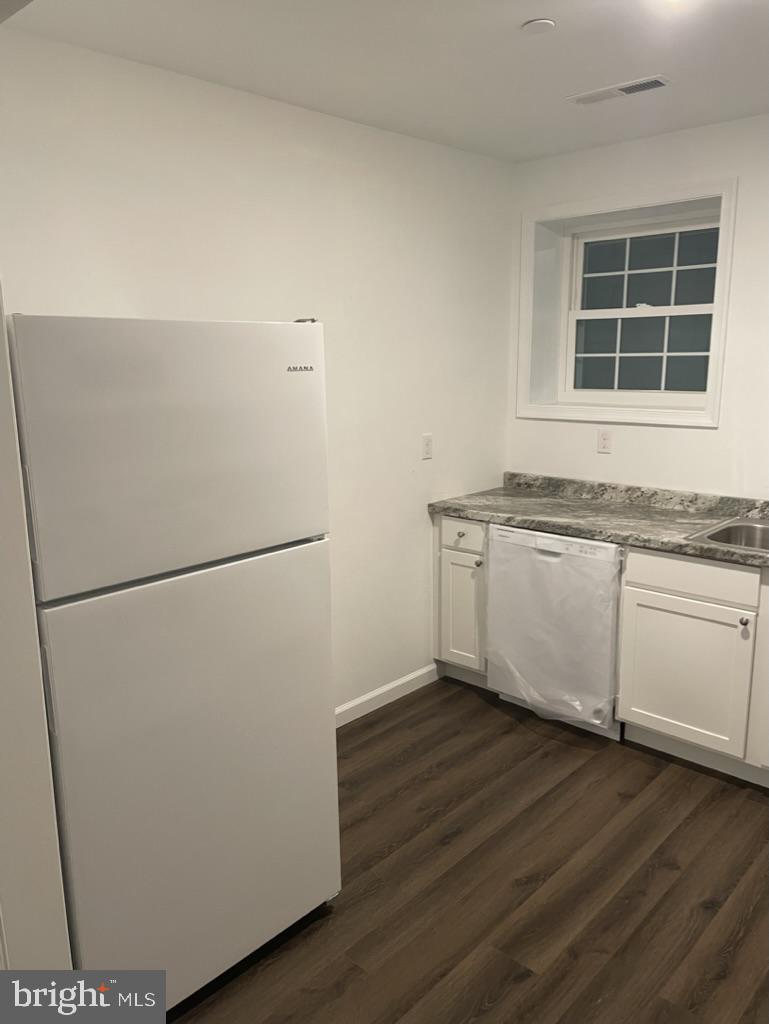 300 Collins Avenue, Unit 3 Hurlock, MD 21643 - Photo 3 of 13 a view of a kitchen with wooden floor and a sink